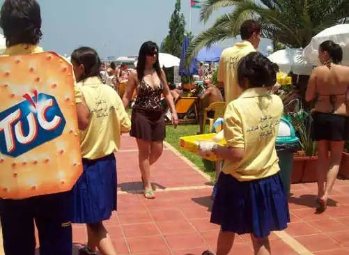 TUC mascot and promoters sampling at a beach resort