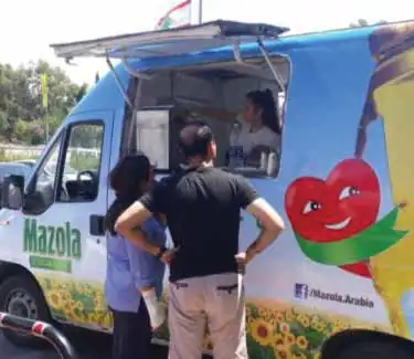 Mazola sampling van with visitors at its window