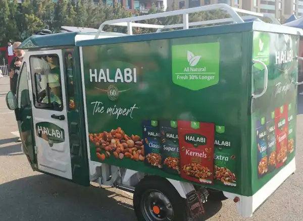 Halabi-branded TukTuk wrapped with nut packs