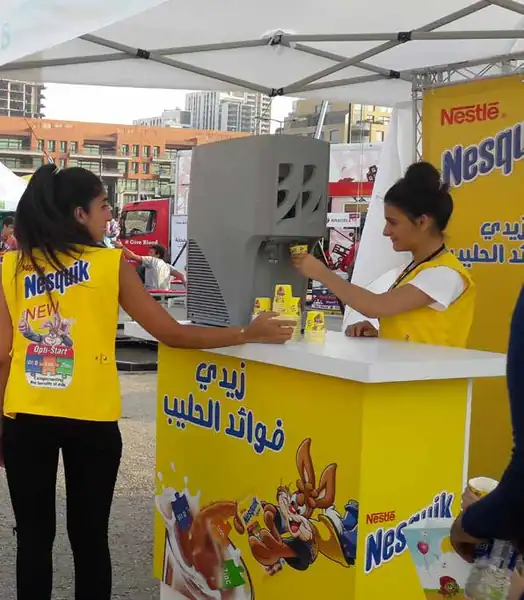 Nesquik promoters serving milk at a sampling stand